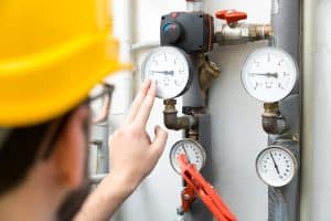 technician checking pressure meters